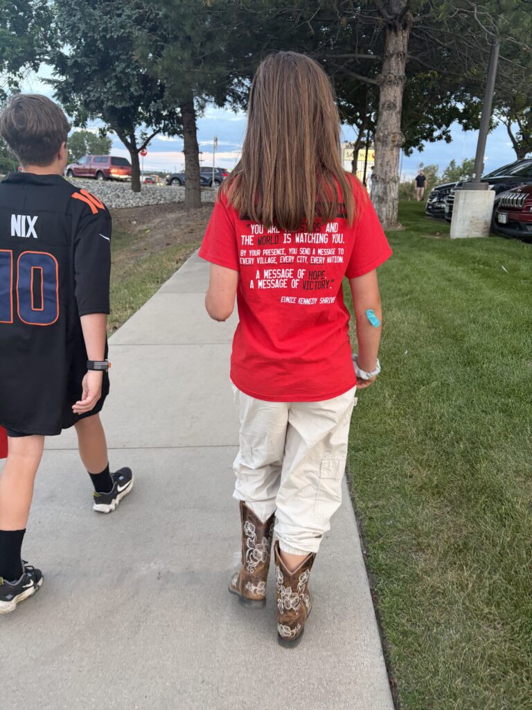 A picture of a girl with a quote from Eunice Kennedy Shriver on the back